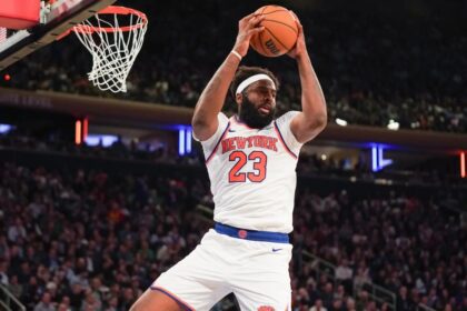 Apr 9, 2026; New York, New York, USA; New York Knicks center Mitchell Robinson (23) secures a rebound during the fourth quarter against the Boston Celtics at Madison Square Garden. Mandatory Credit: Lucas Boland-Imagn Images