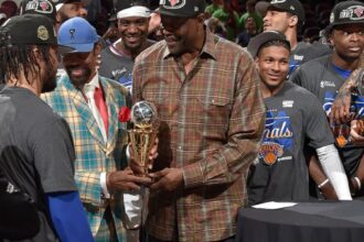 CLEVELAND, OH - MAY 25: Walt Frazier & Patrick Ewing hand Jalen Brunson #11 of the New York Knicks the Larry Bird Trophy after being named the NBA's Eastern Conference Finals Most Valuable Player after Game Four of the 2026 NBA Eastern Conference Finals on May 25, 2026 at Rocket Arena in Cleveland, Ohio. NOTE TO USER: User expressly acknowledges and agrees that, by downloading and/or using this Photograph, user is consenting to the terms and conditions of the Getty Images License Agreement. Mandatory Copyright Notice: Copyright 2026 NBAE (Photo by David Liam Kyle/NBAE via Getty Images)