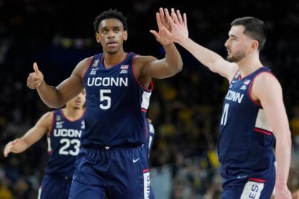 UConn Huskies forwards Tarris Reed Jr. (5) and Alex Karaban (11) high five Monday, April 6, 2026, during the NCAA men's basketball tournament national championship game against the Michigan Wolverines at Lucas Oil Stadium in Indianapolis. Grace Hollars/IndyStar / USA TODAY NETWORK via Imagn Images