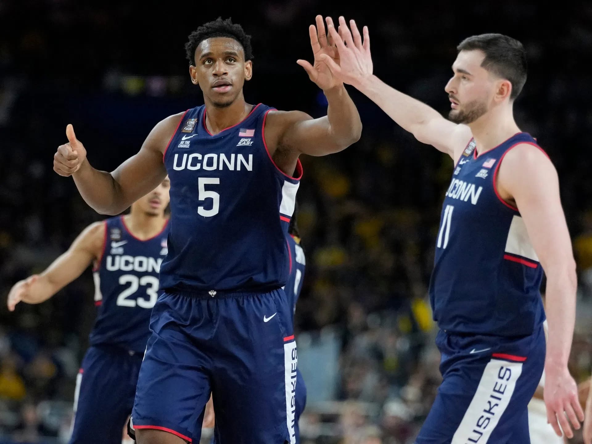 UConn Huskies forwards Tarris Reed Jr. (5) and Alex Karaban (11) high five Monday, April 6, 2026, during the NCAA men's basketball tournament national championship game against the Michigan Wolverines at Lucas Oil Stadium in Indianapolis. Grace Hollars/IndyStar / USA TODAY NETWORK via Imagn Images