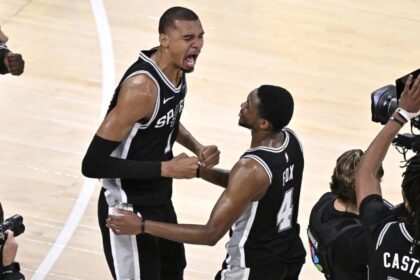 May 30, 2026; Oklahoma City, Oklahoma, USA; San Antonio Spurs forward Victor Wembanyama (1) celebrates with guard De'aaron Fox (4) after defeating the Oklahoma City Thunder in game seven of the western conference finals for the 2026 NBA playoffs at Paycom Center. Mandatory Credit: Jerome Miron-Imagn Images