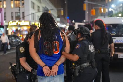 NYPD officers make an arrest after thousands of Knicks fans flooded the streets damaging a police van and a taxi following a historic comeback win against San Antonio Spurs in the NBA Finals Game 4 at Madison Square Garden on June 10, 2026.