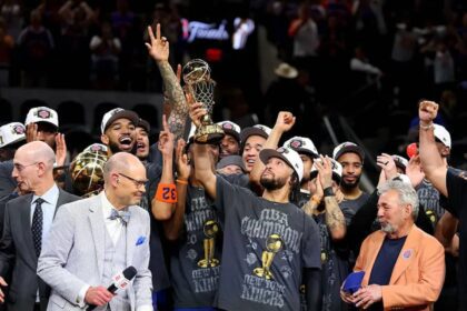 Jalen Brunson #11 of the New York Knicks lifts the Bill Russell NBA Finals Most Valuable Player Award trophy after defeating the San Antonio Spurs in Game Five of the 2026 NBA Finals at Frost Bank Center on June 13, 2026 in San Antonio, Texas.