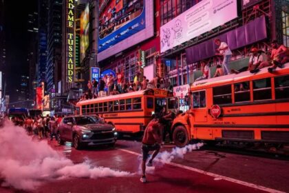 A person kicks a smoke canister as New York Knicks fans celebrate their win against San Antonio Spurs in Game 5 of the NBA Finals in Times Square on June 14, 2026 in New York City.