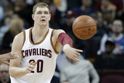 Cleveland Cavaliers' Timofey Mozgov, from Russia, passes against the Indiana Pacers in the first half of an NBA basketball game Monday, Feb. 29, 2016, in Cleveland.