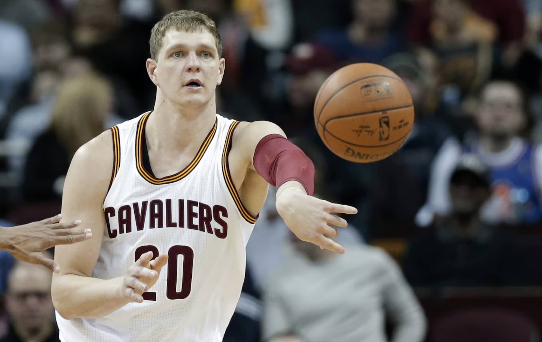 Cleveland Cavaliers' Timofey Mozgov, from Russia, passes against the Indiana Pacers in the first half of an NBA basketball game Monday, Feb. 29, 2016, in Cleveland.