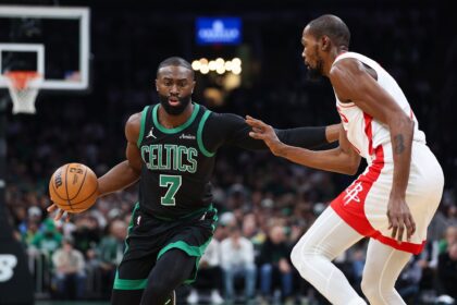 Nov 1, 2025; Boston, Massachusetts, USA; Houston Rockets forward Kevin Durant (7) defends Boston Celtics forward Jaylen Brown (7) during the first half at TD Garden. Mandatory Credit: Paul Rutherford-Imagn Images