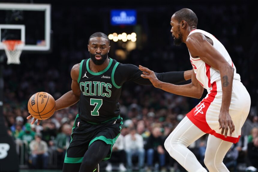Nov 1, 2025; Boston, Massachusetts, USA; Houston Rockets forward Kevin Durant (7) defends Boston Celtics forward Jaylen Brown (7) during the first half at TD Garden. Mandatory Credit: Paul Rutherford-Imagn Images