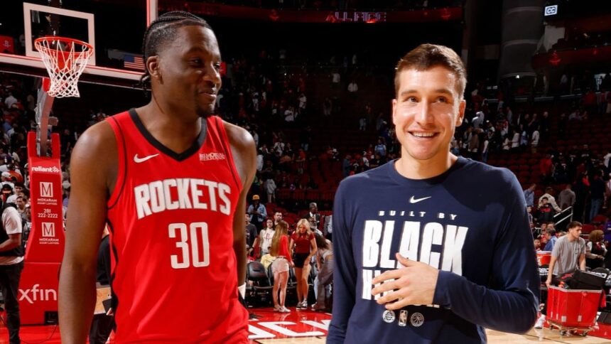 HOUSTON, TX - FEBRUARY 11: Clint Capela #30 of the Houston Rockets and Bogdan Bogdanovic #7 of the Los Angeles Clippers smile after the game on February 11, 2026 at the Toyota Center in Houston, Texas. (Photo by Logan Riely/NBAE via Getty Images)