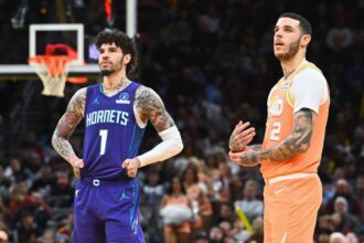 CLEVELAND, OHIO - DECEMBER 22: Lamelo Ball #1 of the Charlotte Hornets and Lonzo Ball #2 of the Cleveland Cavaliers wait for a play during the fourth quarter at Rocket Arena on December 22, 2025 in Cleveland, Ohio. The Cavaliers defeated the Hornets 139-132. (Photo by Jason Miller/Getty Images)
