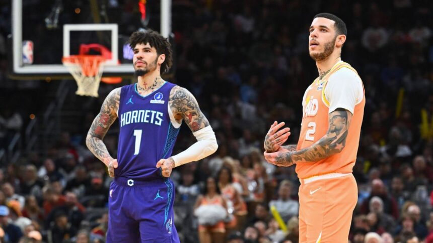 CLEVELAND, OHIO - DECEMBER 22: Lamelo Ball #1 of the Charlotte Hornets and Lonzo Ball #2 of the Cleveland Cavaliers wait for a play during the fourth quarter at Rocket Arena on December 22, 2025 in Cleveland, Ohio. The Cavaliers defeated the Hornets 139-132. (Photo by Jason Miller/Getty Images)